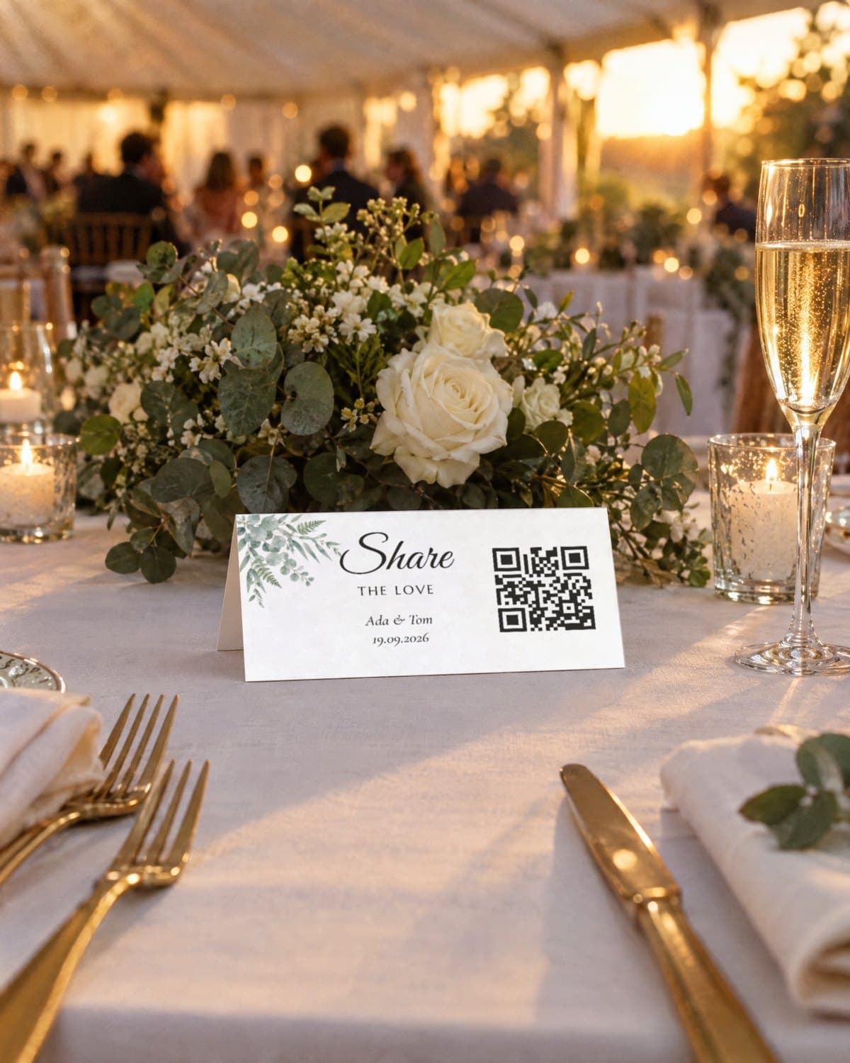 A table tent at Ada & Tom's wedding: the Eucalyptus design with their names, date and QR code, on a reception table with flowers and candles